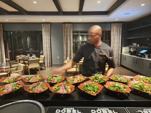 Chef Brian Maylor plating a course at a Bornfidis private dining event