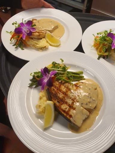 A finished Bornfidis course — grilled fish with an orchid garnish