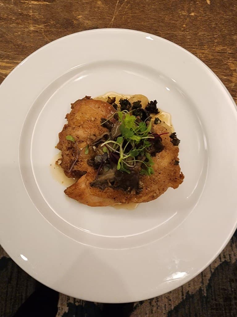 Bornfidis private dining — a guest course plated with herbs and sauce