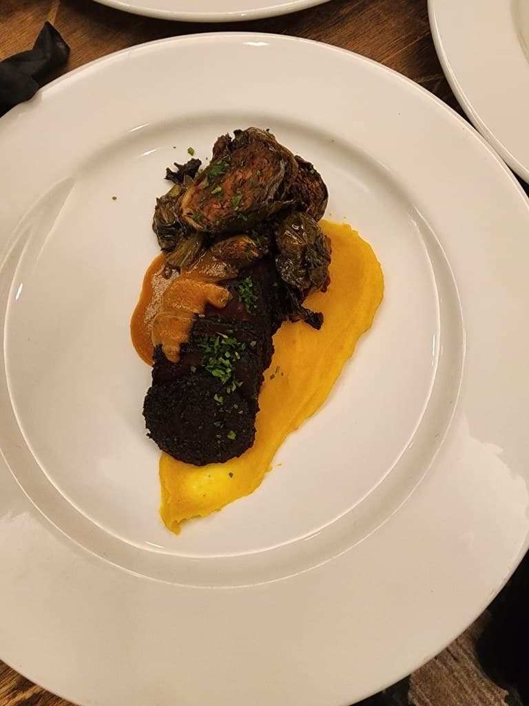 A Bornfidis private dining course — plated with seasonal vegetables and sauce